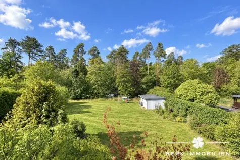 BERK Immobilien – Großzügiges Einfamilienhaus mit Einliegerwohnung in attraktiver Waldrandlage - Aussicht auf Garten aus DG (131623)
