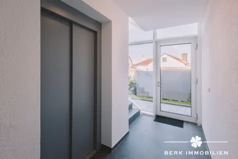 BERK Immobilien – 4-Zimmer-Neubau-Erdgeschosswohnung mit sonniger Terrasse in 1a Lage von Alzenau - Eingang mit Aufzug (130460)