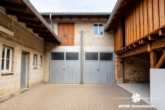 Hof mit Nebengebäude und Garage KI-Generiert - BERK Immobilien – Vielseitiges Zweifamilienhaus mit viel Platz in Mömlingen